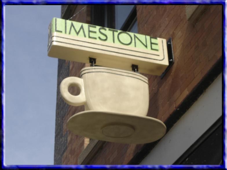 Teacup-shaped carved hanging sign